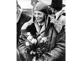 FILE - In a June 26, 1928 file photo, American aviatrix Amelia Earhart poses with flowers as she arrives in Southampton, England, after her transatlantic flight on the "Friendship" from Burry Point, Wales. Bones found in 1940 on a western Pacific Ocean island were quite likely to be remains from famed aviator Amelia Earhart, a new analysis concludes. Until somebody disproves the link, "the most convincing argument is that they are hers," University of Tennessee anthropologist Richard Jantz said in a statement from the institution. (AP Photo, File)