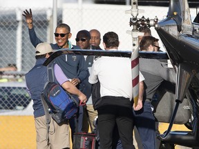 Former President of The United States Barack Obama waves as he prepares to board a helicopter in Auckland, New Zealand, Wednesday, March 21, 2018. Obama is in New Zealand as part of a weeklong tour of Singapore, New Zealand, Australia and Japan.