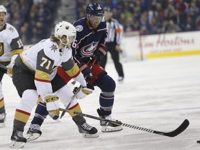 Las Vegas Golden Knights' William Karlsson, left, of Sweden, and Columbus Blue Jackets' Thomas Vanek, of Austria, chase the puck during the first period of an NHL hockey game Tuesday, March 6, 2018, in Columbus, Ohio.