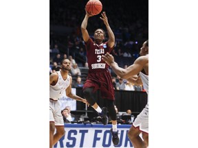 Texas Southern's Demontrae Jefferson (3) shoots against North Carolina Central's Dominique Reid, right, during the first half of a First Four game of the NCAA men's college basketball tournament Wednesday, March 14, 2018, in Dayton, Ohio.