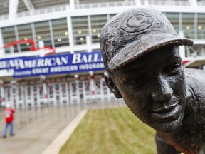 Rain beads up on the statue of Cincinnati Reds great Joe Nuxhall outside Great American Ballpark, Thursday, March 29, 2018, in Cincinnati. Their first game of the regular season against the Washington Nationals was postponed until Friday due to weather.