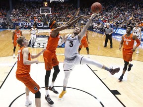 Syracuse's Paschal Chukwu, center left, blocks a shot by Arizona State's Mickey Mitchell (3) during the first half of a First Four game of the NCAA men's college basketball tournament Wednesday, March 14, 2018, in Dayton, Ohio.