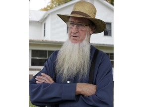 In this Oct. 10, 2011 file photo, Sam Mullet Sr. stands in the front yard of his home in Bergholz, Ohio. Mullet, the leader of a breakaway Amish group in Ohio convicted in hair- and beard-cutting attacks, is pushing to get his convictions overturned using arguments already rejected in court. An attorney for 72-year-old Samuel Mullet Sr. says Mullet's previous lawyer made mistakes during trial and in prior appeals. In a Monday, March 19, 2018 court filing, prosecutors say there were no errors that amounted to Mullet's rights to due process being violated, and a judge should reject his request.