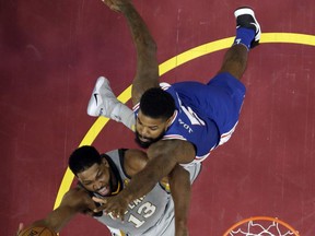 Cleveland Cavaliers' Tristan Thompson, left, drives to the basket against Philadelphia 76ers' Amir Johnson in the first half of an NBA basketball game, Thursday, March 1, 2018, in Cleveland.
