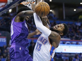 Oklahoma City Thunder forward Paul George (13) is fouled by Phoenix Suns guard Josh Jackson, left, as he shoots during the first half of an NBA basketball game in Oklahoma City, Thursday, March 8, 2018.
