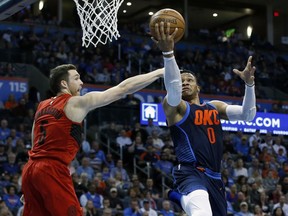 Oklahoma City Thunder guard Russell Westbrook (0) shoots in front of Portland Trail Blazers guard Pat Connaughton (5) in the first half of an NBA basketball game in Oklahoma City, Sunday, March 25, 2018.