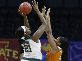 Baylor center Kalani Brown (21) shoots as Texas forward Jatarie White, right, defends, in the first half of an NCAA college basketball game in the championship game of the women's Big 12 conference tournament in Oklahoma City, Monday, March 5, 2018.