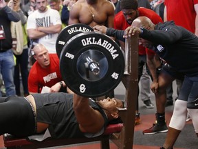 Oklahoma offensive lineman Orlando Brown lifts weights during an NCAA college football Pro Day workout in Norman, Okla., Wednesday, March 14, 2018. Brown had a historically bad NFL Scouting Combine and is trying to improve his falling draft stock at Oklahoma's Pro Day.