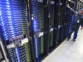 FILE - In this Oct. 15, 2013, file photo, Chuck Goolsbee, site director for Facebook's Prineville data centers, shows the computer servers that store users' photos and other data, at the Facebook site in Prineville, Ore. Facebook frequently defends its data collection and sharing activities by noting that it's adhering to a privacy policy it shares with users.