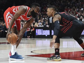 Houston Rockets guard James Harden looks to get past Portland Trail Blazers guard Damian Lillard during the first half of an NBA basketball game in Portland, Ore., Tuesday, March 20, 2018.