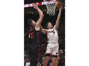 Miami Heat guard Goran Dragic (7) drives to the basket against Portland Trail Blazers center Jusuf Nurkic during the first half of an NBA basketball game in Portland, Ore., Monday, March 12, 2018.