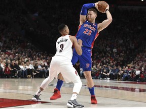 Portland Trail Blazers guard CJ McCollum defends against Detroit Pistons forward Blake Griffin during the first half of an NBA basketball game in Portland, Ore., Saturday, March 17, 2018.