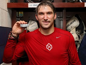 Washington Capitals' Alex Ovechkin holds up a puck adorned with the No. 600 to acknowledge him reaching the 600-goal plateau in a 3-2 win over the Winnipeg Jets in NHL action Monday night in Washington. Ovechkin had a pair of goals on the night.
