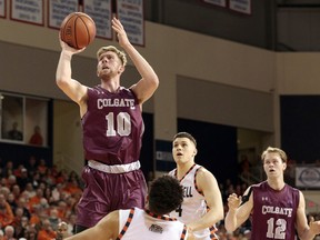 Colgate's Will Rayman (10) shoots over Bucknell's Stephen Brown during the first half of an NCAA college basketball game for the Patriot League men's tournament championship in Lewisburg, Pa., Wednesday, March 7, 2018.