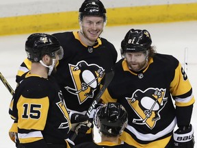 Pittsburgh Penguins' Jamie Oleksiak (6) celebrates his goal with Phil Kessel (81) Riley Sheahan (15) and Justin Schultz (4) in the first period of an NHL hockey game against the Dallas Stars in Pittsburgh, Sunday, March 11, 2018.