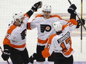 Philadelphia Flyers' Robert Hagg (8) celebrates his goal with Andrew MacDonald (47), and Wayne Simmonds (17) in the first period of an NHL hockey game against the Pittsburgh Penguins in Pittsburgh, Sunday, March 25, 2018.