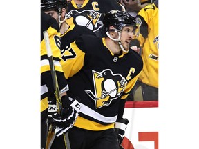 Pittsburgh Penguins' Sidney Crosby returns to the bench after scoring during the second period of the team's NHL hockey game against the Montreal Canadiens in Pittsburgh, Wednesday, March 21, 2018.