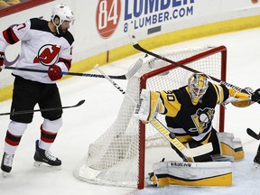 Pittsburgh Penguins goaltender Matt Murray (30) blocks a shot with New Jersey Devils' Patrick Maroon (17) looking for a rebound during the first period of an NHL hockey game in Pittsburgh, Friday, March 23, 2018.