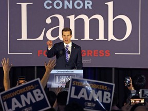 Conor Lamb, the Democratic candidate for the March 13 special election in Pennsylvania's 18th Congressional District celebrates with his supporters at his election night party in Canonsburg, Pa., early Wednesday, March 14, 2018. A razor's edge separated Lamb and Republican Rick Saccone early Wednesday in their closely watched special election in Pennsylvania, where a surprisingly strong bid by first-time candidate Lamb severely tested Donald Trump's sway in a GOP stronghold.