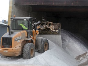 A heavy equipment operator with the Hazleton Department of Public Works uses a loader to move anti-skid material as the city along with other municipalities and the state gear up for another winter storm on Tuesday, March 20 ,2018 in Hazleton, Pa.