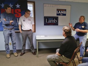 Denny Cregut, right, the finance director for the local United Steelworkers of America Local 14693, asks Democrat Conor Lamb, left, about his stance on the newly mentioned steel import tariff during a campaign stop during a meeting of the Union Veterans Council, Thursday, March 8, 2018 in Canonsburg, Pa. Lamb is running against Republican Rick Saccone in a special election being held on March 13 for the PA 18th Congressional District vacated by Republican Tim Murphy.