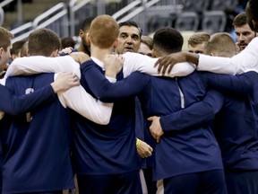 Villanova coach Jay Wright, center, talks with his team as they huddle during practice for an NCAA college basketball first round game in Pittsburgh, Wednesday, March 14, 2018.
