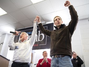 Cecil Roberts, president of the United Mine Workers, left, lifts up Democratic candidate Conor Lamb's hand as the crowd erupts in cheers and chants during a rally, Sunday, March 11, 2018, at the Greene County Fairgrounds in Waynesburg, Pa. Lamb is running against state Rep. Rick Saccone for Pennsylvania's 18th Congressional District in a special election on Tuesday.