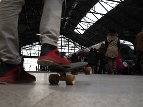 A man waits at the Saint Lazare station, Thursday, March 22, 2018 in Paris. French trains, flights, schools and other public services are set to be disrupted by nationwide strikes to protest against President Emmanuel Macron's economic measures.