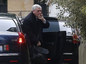 Thierry Herzog, a lawyer for former French President Nicolas Sarkozy, arrives at Sarkozy's home in Paris, Thursday, March 22, 2018. Sarkozy was handed preliminary charges Wednesday over allegations he accepted millions of euros in illegal campaign funding from the late Libyan leader Moammar Gadhafi.