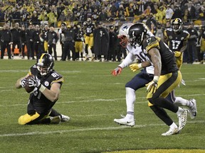 Pittsburgh Steelers tight end Jesse James, left, had this touchdown catch called back because of the catch rule in the fourth quarter of an NFL game against the New England Patriots on Dec. 17, 2017.
