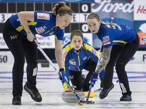 Sweden skip Anna Hasselborg delivers a shot swept by lead Sofia Mabergs, right, and second Agnes Knochenhauer as they play Russia during the semifinals at the World Women's Curling Championship in North Bay, Ont., Saturday, March 24, 2018.
