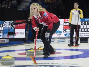 Canada skip Jennifer Jones marks a shot as China skip Yilun Jiang looks on at the World Women's Curling Championship in North Bay, Ont., Monday, March 19, 2018.