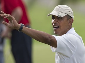 FILE--In this Jan. 1, 2014, file photo, President Barack Obama waves to people along the 18th green at Mid-Pacific County Club in Kailua, Hawaii. A state Senate committee in Hawaii is calling for a statue of former President Barack Obama to be erected in the state where he was born.