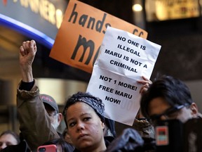 FILE - In this Jan. 16, 2018, file photo, supporters look on as Maru Mora-Villalpando speaks at a news conference in Seattle announcing that the longtime activist for illegal immigrants in the Northwest says she herself is now facing deportation. A federal judge in Seattle has opened the door for thousands of immigrants to apply for asylum, finding that the Department of Homeland Security has routinely failed to notify them of a deadline for filing their applications.