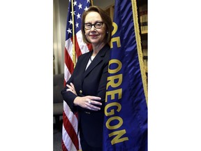 FILE--In this July 13, 2016, Oregon Attorney General Ellen Rosenblum poses for a photo at her office in Portland, Ore. Rosenblum says Facebook might have violated a new state law that protects online customers' private information and also disclosed in an interview with AP that she and several other state attorneys general are drafting a letter to Facebook, asking how it allowed a developer to weaponize the data of millions of customers, and says a full-scale investigation might ensue.