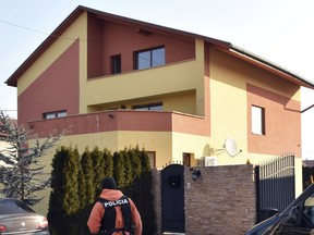 A policeman stands outside of a house linked to Antonin Vadala, an Italian businessman who did business with at least two officials close to Slovakia's Prime Minister Robert Fico, Thursday, March 1, 2018. Police are conducting raids in eastern Slovakia in houses linked to the members of Italian mafia in the country that an investigative journalist was writing about before he was shot dead last week.