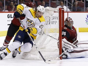 Nashville Predators left wing Kevin Fiala (22) tries to shoot against Arizona Coyotes goaltender Darcy Kuemper (35) during the first period of an NHL hockey game Thursday, March 15, 2018, in Glendale, Ariz.