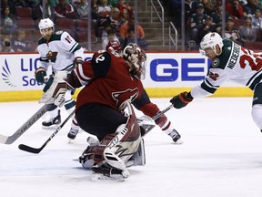 Minnesota Wild right wing Nino Niederreiter (22) scores a goal against Arizona Coyotes goaltender Antti Raanta (32) as Wild left wing Jason Zucker (16) looks on during the first period of an NHL hockey game Saturday, March 17, 2018, in Glendale, Ariz.