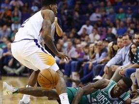 Boston Celtics guard Terry Rozier III (12) loses control of the ball as Phoenix Suns guard Elfrid Payton, left, defends during the first half of an NBA basketball game Monday, March 26, 2018, in Phoenix.
