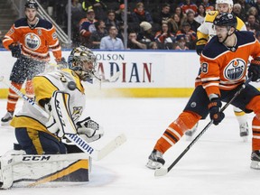 Goaltender Pekka Rinne makes one of his 34 saves on the night against Edmonton Oilers' Anton Slepyshev during NHL action Thursday in Edmonton. The Preds were 4-2 winners.