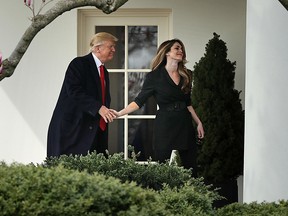 Donald Trump shakes hands with Communications Director Hope Hicks on her last day of work at the White House before he departs March 29, 2018 in Washington, DC.