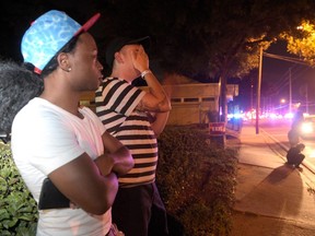 Jermaine Towns, left, and Brandon Shuford wait near Pulse nightclub in Orlando, Fla., June 12, 2016.