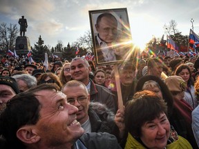 Supporters of President Vladimir Putin celebrate the fourth anniversary of Russia's annexation of Crimea in Sevastopol on March 14, 2018.