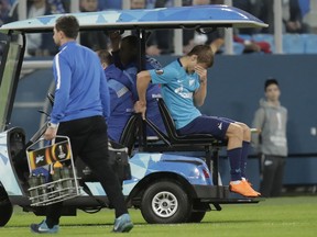 Zenit's Alexsander Kokorin leaves the field after getting injured during the Europa League round of sixteen second leg soccer match between Zenit St. Petersburg and Leipzig, at the Saint Petersburg stadium in St.Petersburg, Russia, Thursday, March 15, 2018.