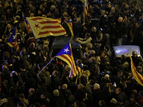 Large crowds, some with Catalan independence flags, gather in Barcelona, Spain, Friday, March 23, 2018 to protest the jailing of Catalan politicians. A Spanish Supreme Court judge has charged 13 leading Catalan separatist politicians with rebellion for their recent attempts to bring about the region's independence from Spain. The indictment deals a heavy blow to the secessionist movement as it could put its political elite behind bars for decades.