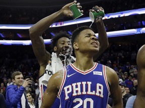 Philadelphia 76ers' Markelle Fultz, right, has water poured on him by Robert Covington after an NBA basketball game against the Denver Nuggets, Monday, March 26, 2018, in Philadelphia. Philadelphia won 123-104.