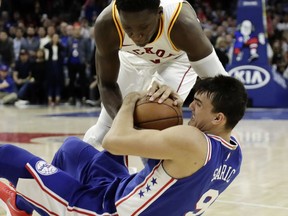 Indiana Pacers' Victor Oladipo, top, and Philadelphia 76ers' Dario Saric battle for the ball during the second half of an NBA basketball game, Tuesday, March 13, 2018, in Philadelphia. Indiana won 101-98.