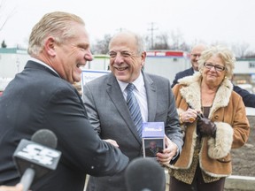 Doug Ford, with his mother Dianne Ford,  shakes hands with Dr. Rueben Devlin, president  CEO, Humber River Hospital.