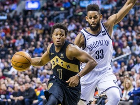 Kyle Lowry of the Toronto Raptors drives past Brooklyn Nets' Allen Crabbe during NBA action Friday at the ACC. Lowry had a team-high 25  points in a 116-112 victory.