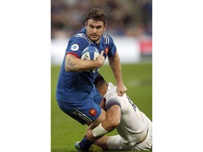 France's Marco Tauleigne, left, is tackled by England's Ben Te'o during the Six Nations rugby union match between France and England at the Stade de France stadium in Saint-Denis, north of Paris, Saturday, March 10, 2018.